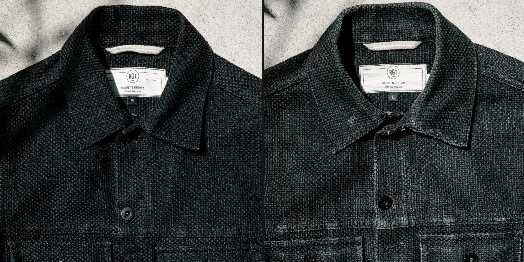 Two black jackets with labels on a textured gray background